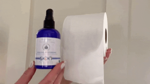 Pristine Cleansing Sprays toilet paper spray being sprayed onto toilet paper