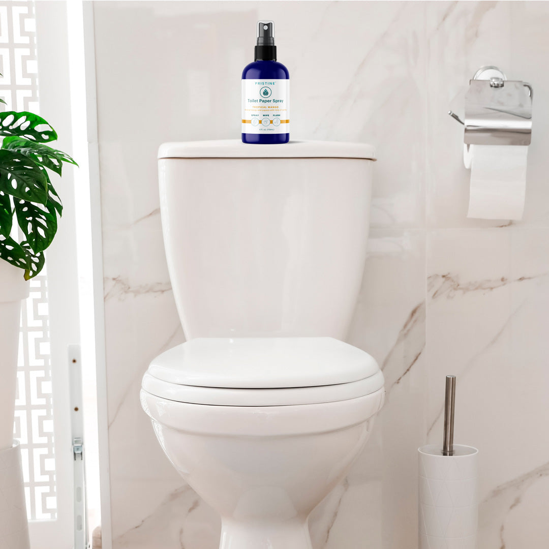 Pristine toilet paper spray wet wipe alternative bottle positioned on back of toilet