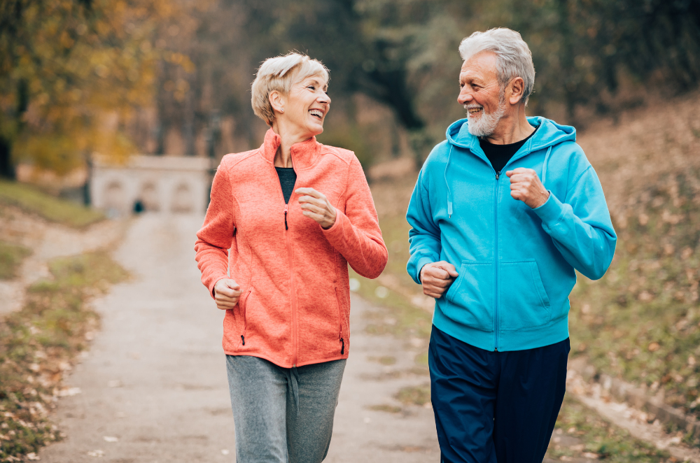 Senior man and woman jogging in park