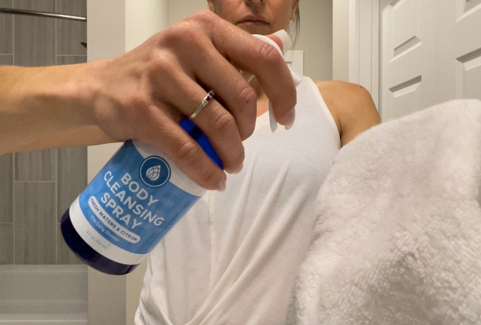 Woman spraying Pristine Body Cleansing Spray onto cloth