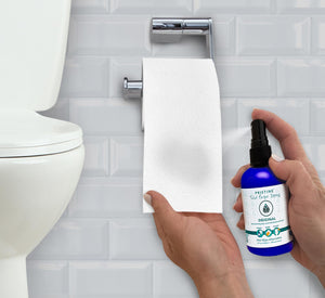 Pristine Toilet Paper Spray being sprayed onto toilet paper.