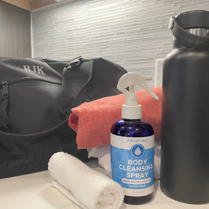 Pristine Body Cleansing Spray Long Shower positioned near gym bag, water bottle, and gym towel.